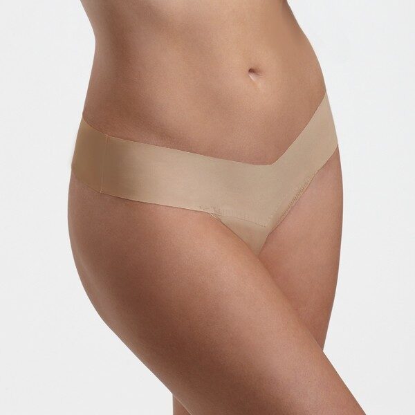 A model shown from the waist down wears the Hanky Panky Bare Natural Rise thong in taupe. It is a seamless thong panty.
