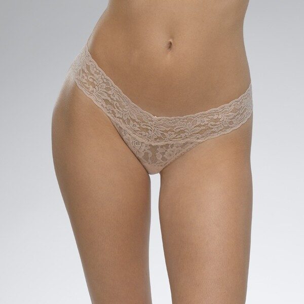 A model shown from the waist down wears the Hanky Panky Signature lace low Rise thong in Chai a pinkish beige. It is a stretch lace low rise thong panty.