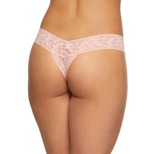 A model shown from the waist down (back view) wears the Hanky Panky Signature lace low Rise thong in a light pink. It is a stretch lace low rise thong panty.