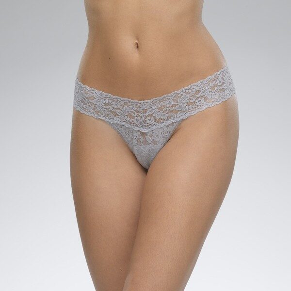A model shown from the waist down wears the Hanky Panky Signature lace low Rise thong in Steel, a light bluish gray. It is a stretch lace low rise thong panty.