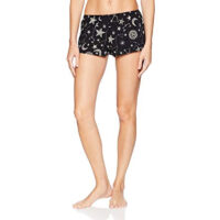 A model shown from the waist down wears the Only Hearts Seeing Stars lounge shorts. The shorts are navy and feature a print of moons, stars and constellations printed in white and light pink. They are a loose fit but short inseam shorter than boxer shorts.