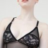 A close-up torso view of the Iona bodysuit- made of sheer black mesh and lace panels.