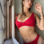 model wears only hearts organic cotton bralette and thong set in red hearts print