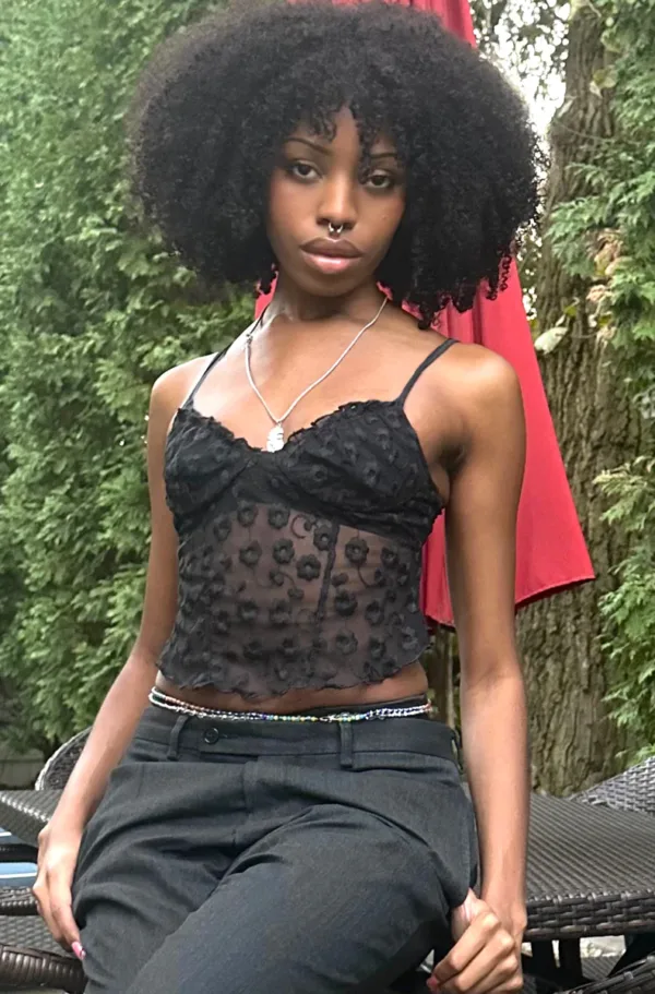 model wears the virginia embroidered corset cami in black