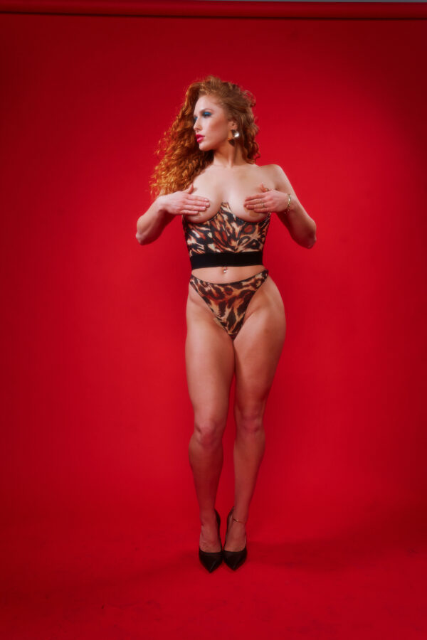 model wears kilo brava's ocelot mesh underbust bustier and high leg thong