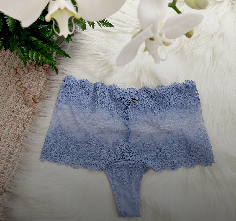 a pair of periwinkle blue lace panties lay atop a white fur rug