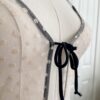 close up of the front of the only hearts coucou lola two-toned brigitte body teddy in cream with black trim (on a dress form)