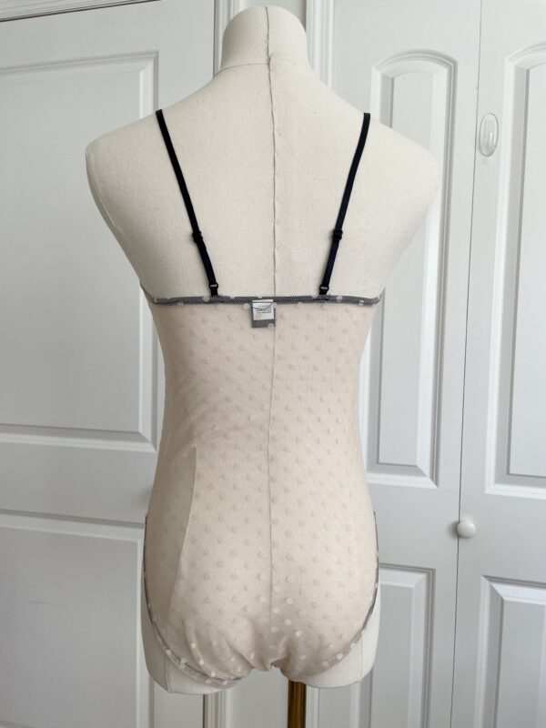 back view of only hearts coucou lola two-toned brigitte body teddy in cream with black trim (on a dress form)