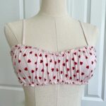 only hearts organic cotton Joey bralette in pink with red hearts (on a dress form)