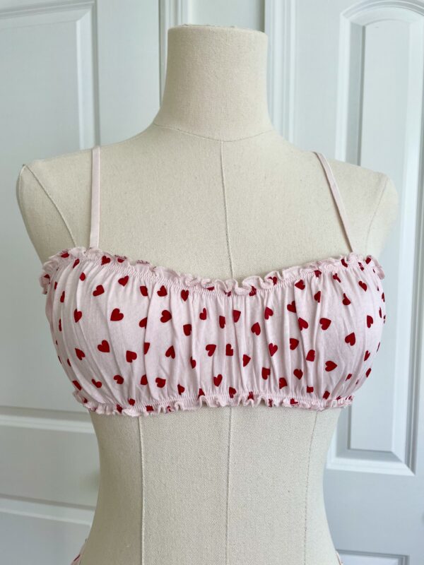 only hearts organic cotton Joey bralette in pink with red hearts (on a dress form)