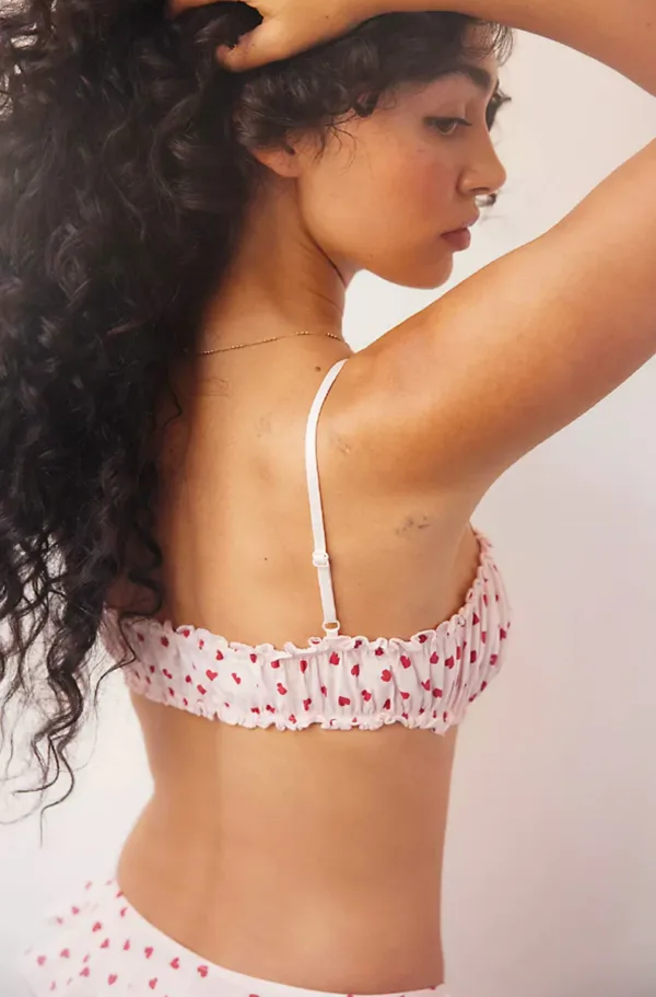 model wears the only hearts organic cotton joey bralette in cotton candy pink (back view)