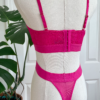 back view of kilo brava azalea pink stretch lace bralette and high leg thong set