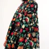 a model looks back over their shoulder while wearing the only hearts carmen velvet embroidered kimono. it is untied and the black belt hangs loose