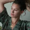a model holds their hair and wears the only hearts luv island cotton kaftan