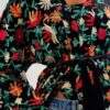 medium close up of a model wearing the only hearts carmen embroidered kimono. the kimono is tied closed with the black velvet belt.