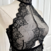 mannequin posed with black lingerie. mannequin wearing the only hearts so fine lace halter cami. the mannequin is standing in front of a white door.