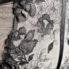 close up view the fabric on a mannequin wearing the kilo brava black embroidered lace underwire bodysuit.