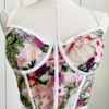 waist-up view of a mannequin wearing lingerie in front of white doors. mannequin wears the kilo brava floral embroidered underwire bustier