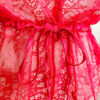 close in view of the red eyelash lace of the kilo brava eyelash lace teddy in red. here we can see the satin belt tied in a bow at the waist as well.