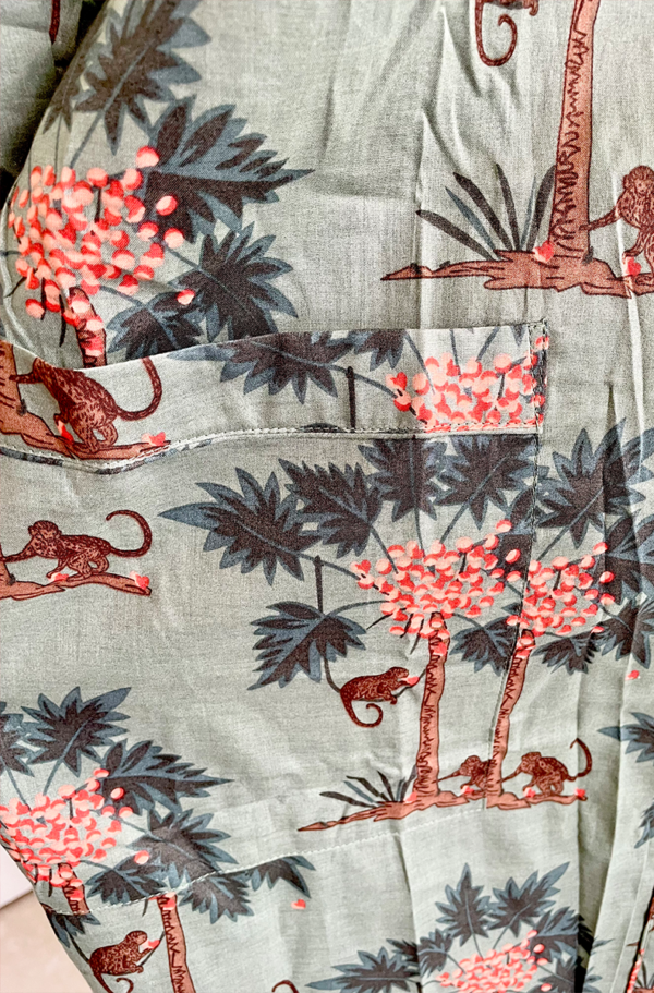 close up view of the fabric used for the only hearts luv island cotton kimono robe, shorty pj set, kaftan, and luv island night dress in moss green with a tropical print.