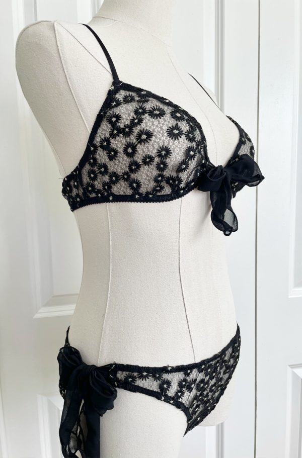 side view of the only hearts isabel embroidered black lace bralette and bikini brief