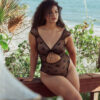 model sits wearing the kilo brava teddy in black bows mesh