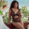 model sits wearing the kilo brava teddy in black bows mesh