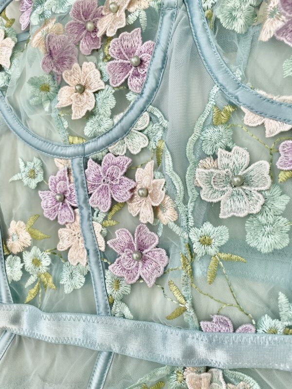 close up of the fabric of the Kilo Brava powder blue 3D floral underwire bodysuit