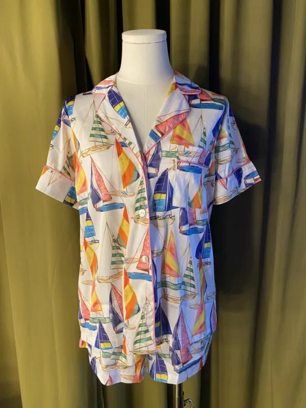 Satin Shortie PJ Set in Sail Away displayed on a mannequin, featuring vintage sailboat print, pink piping, and silky simulated silk fabric.