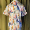 Satin Shortie PJ Set in Sail Away displayed on a mannequin, featuring vintage sailboat print, pink piping, and silky simulated silk fabric.