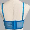 back view of kilo brava embroidered lace longline bralette in Hawaiian blue. Bra pictured on a mannequin in front of a gray backdrop