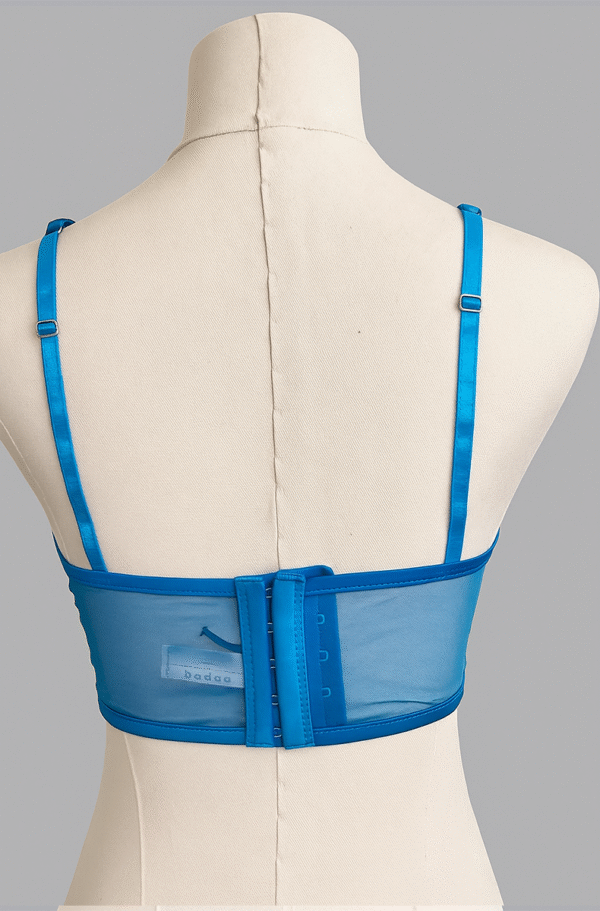 back view of kilo brava embroidered lace longline bralette in Hawaiian blue. Bra pictured on a mannequin in front of a gray backdrop